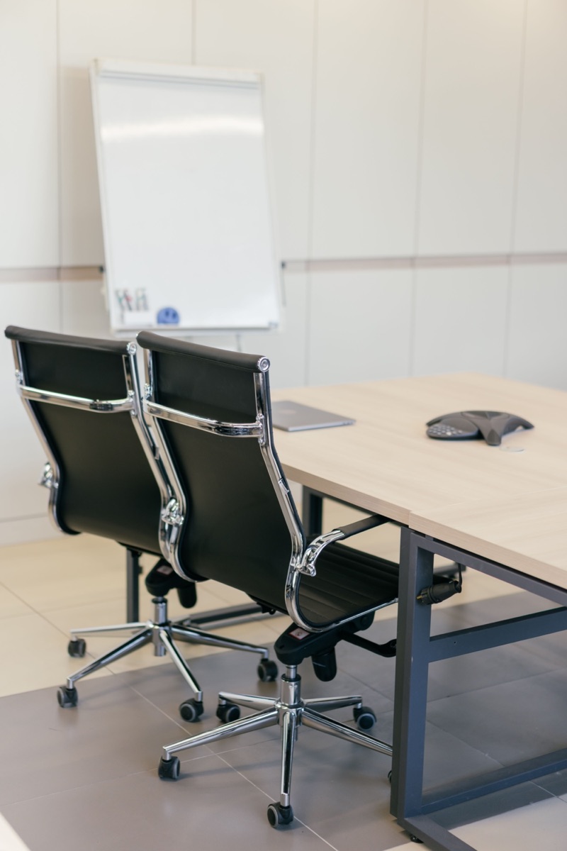 Tidy office meeting room with chairs and a clean conference table